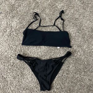 Bikini in black. Adjustable top. Bottom has sexy design and fit.